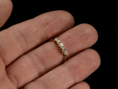 thumbnail of Antique c1900 ring with five small diamonds set in a row in 18K yellow gold. Shown on hand.