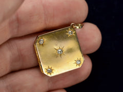 thumbnail of c1900 Diamond-Shaped Five Diamond Locket in yellow gold, shown on  hand for scale.