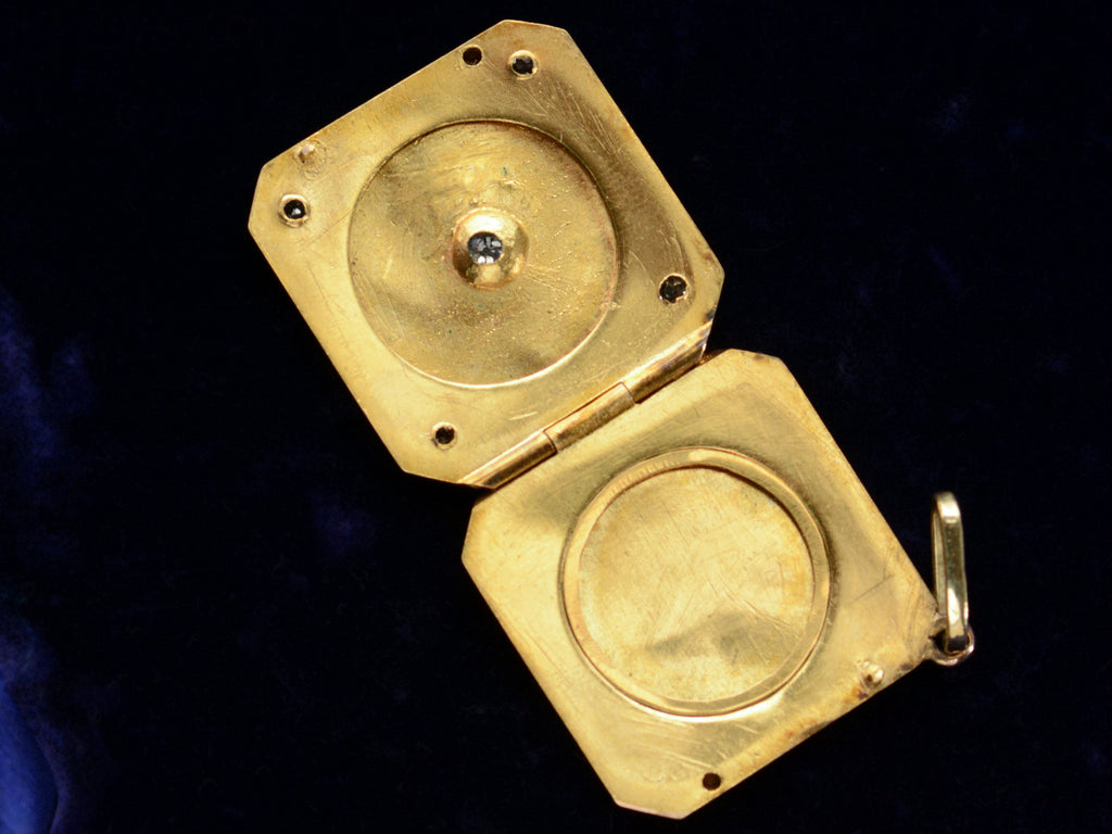 c1900 Diamond-Shaped Five Diamond Locket in yellow gold, shown open on a dark blue background.