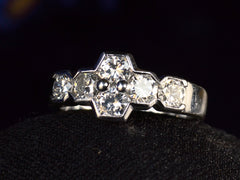 thumbnail of Angled view of vintage c1960 white gold ring with a cluster of six diamonds. Shown on dark background.