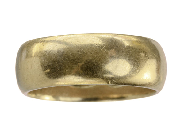 A wide antique 18K yellow gold wedding band with patinated surface, shown on white background.