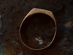 thumbnail of Side profile of c1890 Victorian signet ring in rose gold with black enamel details and the letter "B" on the face. Shown on dark background.
