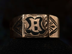 thumbnail of Front of antique c1890 Victorian signet ring in rose gold with black enamel details and the letter "B" on the face. Shown on dark background.