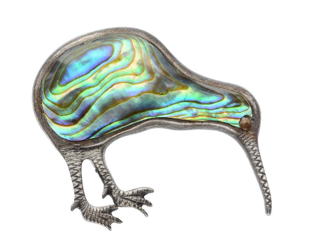 A kiwi bird brooch with iridescent abalone shell set in silver, shown on white background.