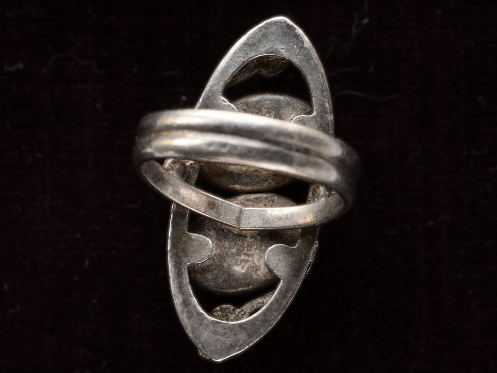 Inside view of silver c1910 Arts & Crafts movement ring on black background.