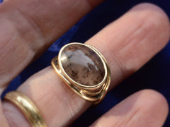 thumbnail of Font view of oval dendritic agate ring in yellow gold. Shown on finger.