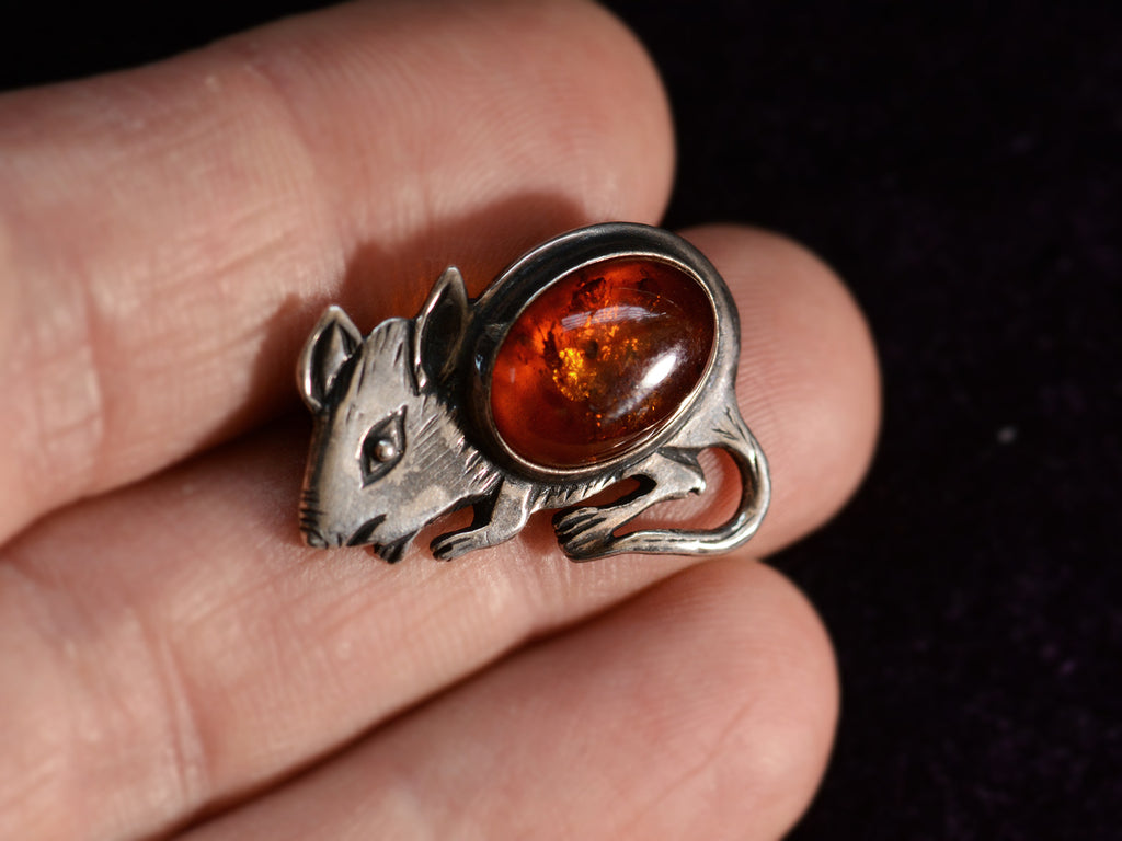 Front side of Vintage Sterling Silver and Amber Mouse Brooch (on hand for scale)