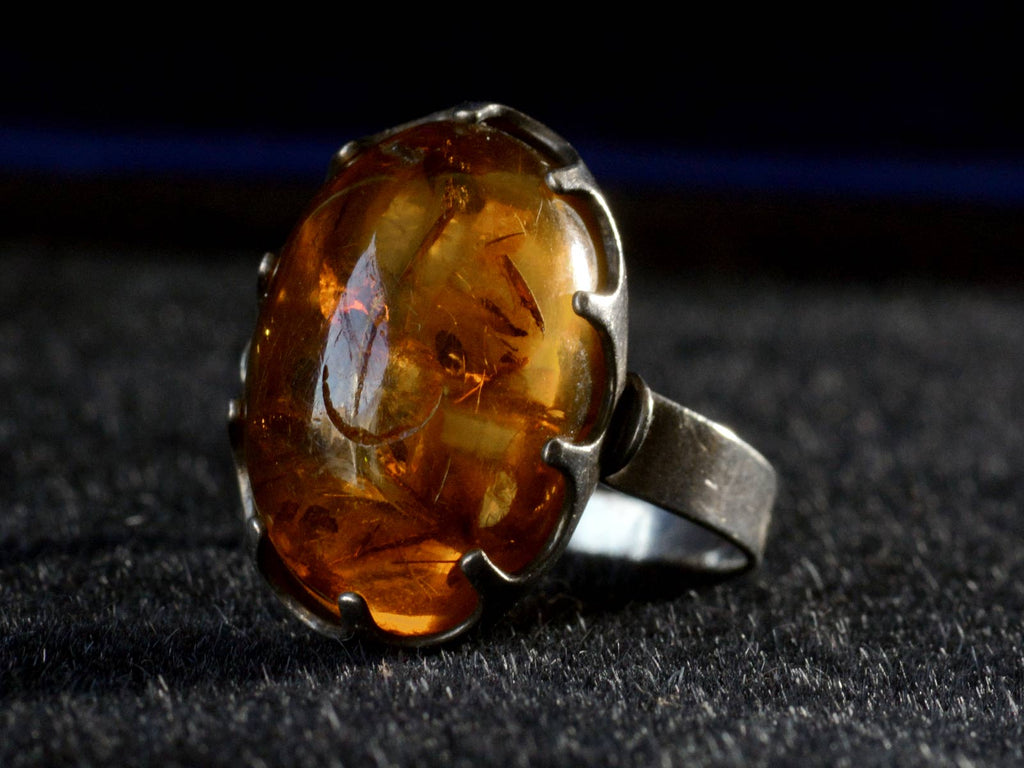 Right angle view c1970 Amber and Silver Ring (on black background)