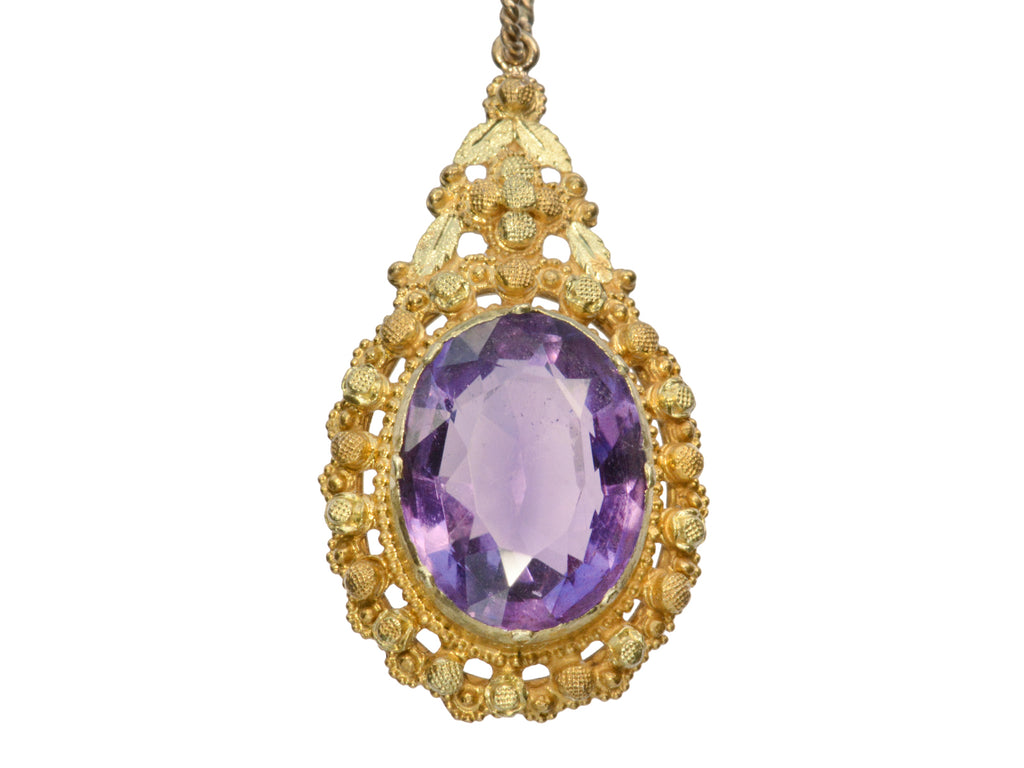 Detail of c1880 oval amethyst and yellow gold pendant, shown on white background.