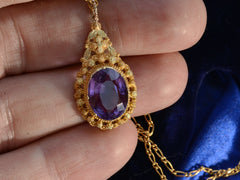 thumbnail of c1880 oval amethyst and yellow gold pendant, shown on hand for scale.