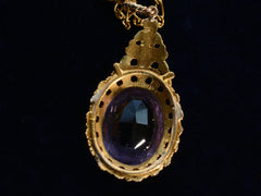 thumbnail of Detail of reverse side of c1880 oval amethyst and yellow gold pendant, shown on dark background.