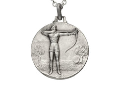 thumbnail of Detail of a vintage white metal archery medal with an archer pictured in relief. Shown on white background.