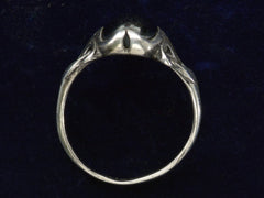 thumbnail of c1910 Art Nouveau Black Onyx Ring in Silver, side profile on dark blue background