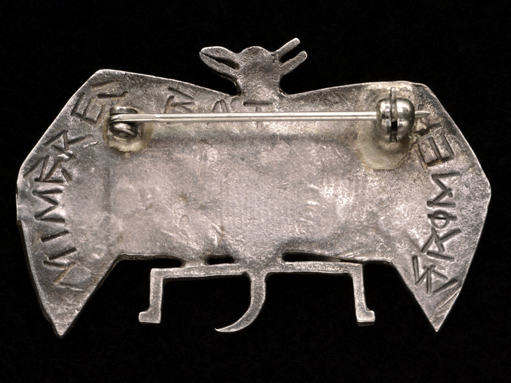 Reverse side of c1980 Silver Bat Brooch on black background. Signed but illegibly. Possibly "MIMBREC BAT GROMER"