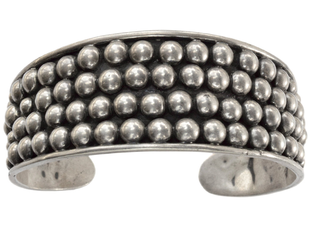 A vintage wide silver cuff bracelet featuring three rows of small, raised silver beads across the front, on a plain white background.
