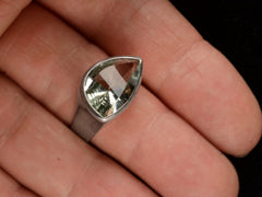 thumbnail of Silver ring with faceted light green eye-shaped stone, shown on finger