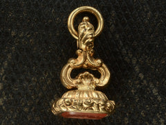thumbnail of Side profile view of Georgian-era gold fob with a carnelian intaglio shown on dark textured background.