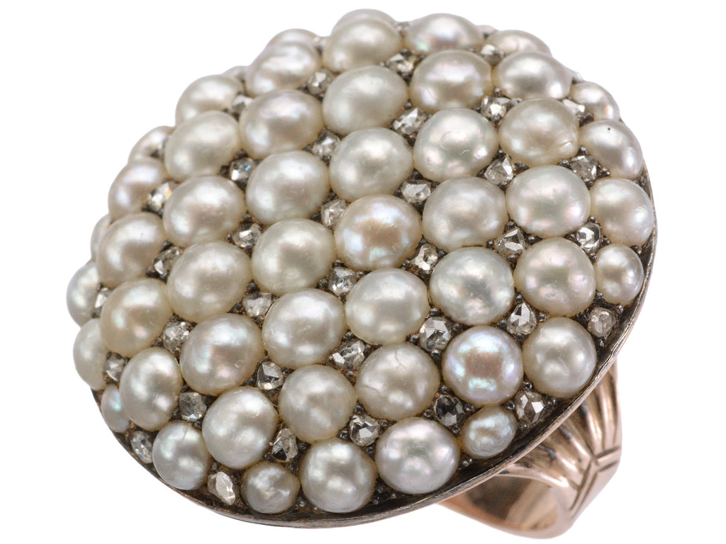 Angled view of Victorian ring with a large luster pearls and rose cut diamonds, set in rosy-yellow gold, shown on white background.
