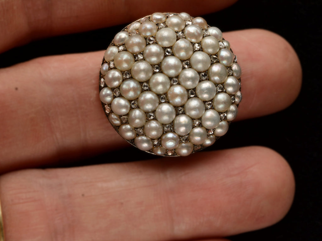 Victorian ring with a large luster pearls and rose cut diamonds, set in rosy-yellow gold, shown on finger