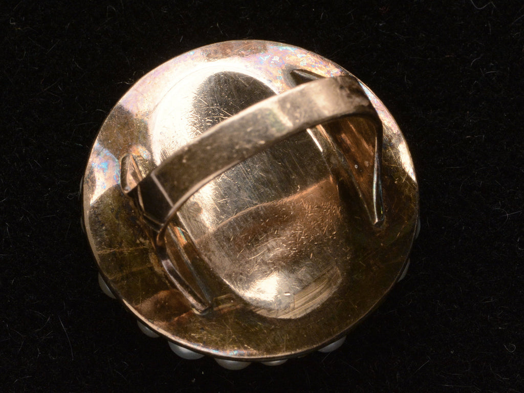 Inside view of Victorian ring with a large luster pearls and rose cut diamonds, set in rosy-yellow gold, shown on dark background.