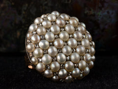 thumbnail of Angled left view of Victorian ring with a large luster pearls and rose cut diamonds, set in rosy-yellow gold, shown on dark background.