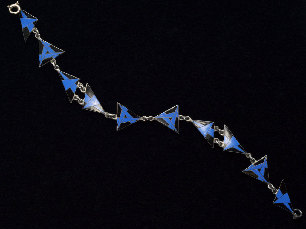 Art Deco silver bracelet with blue and black geometric triangle links on a black background