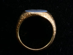 thumbnail of Side profile view of antique gold signet ring with oval blue chalcedony face, on dark background.
