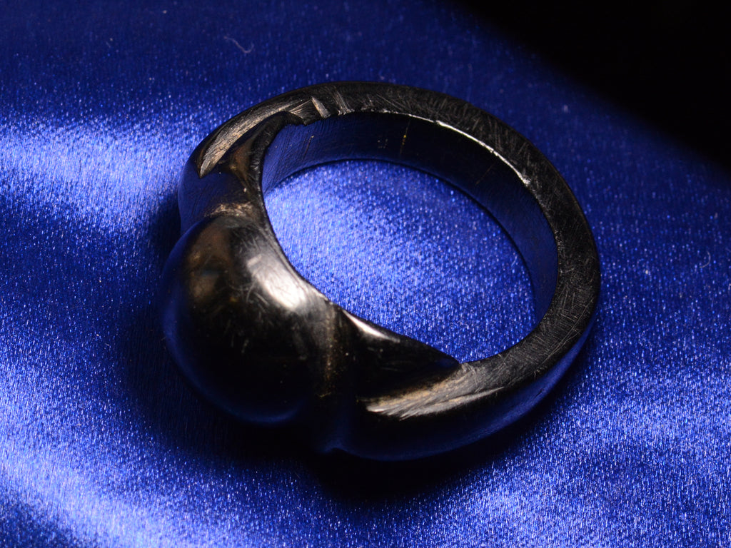 Elevated profile view of c1880 Black Bog Oak Ring (on blue background)