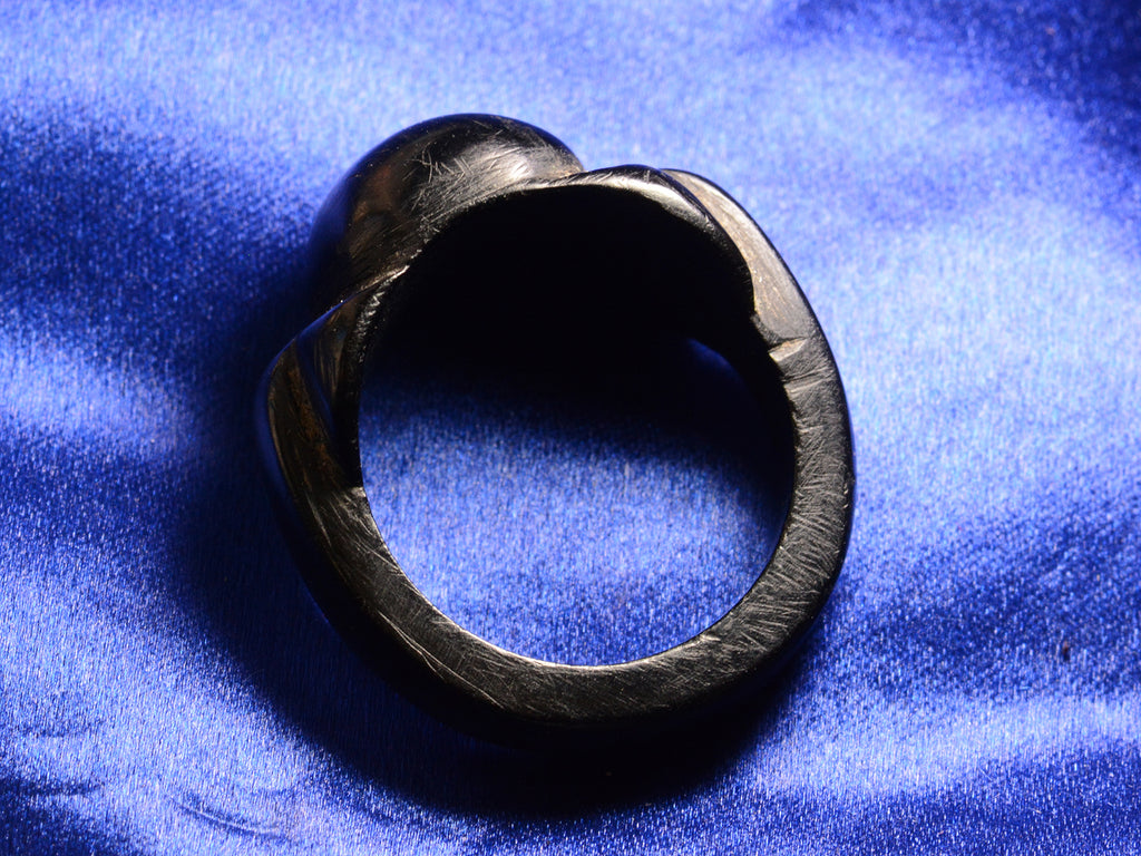 Side profile view of c1880 Black Bog Oak Ring (on blue background)