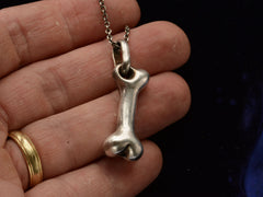 thumbnail of Vintage silver bone-shaped pendant on hand