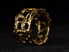 thumbnail of Right angle view of wide brutalist wedding band in 18k yellow gold, shown on black background.