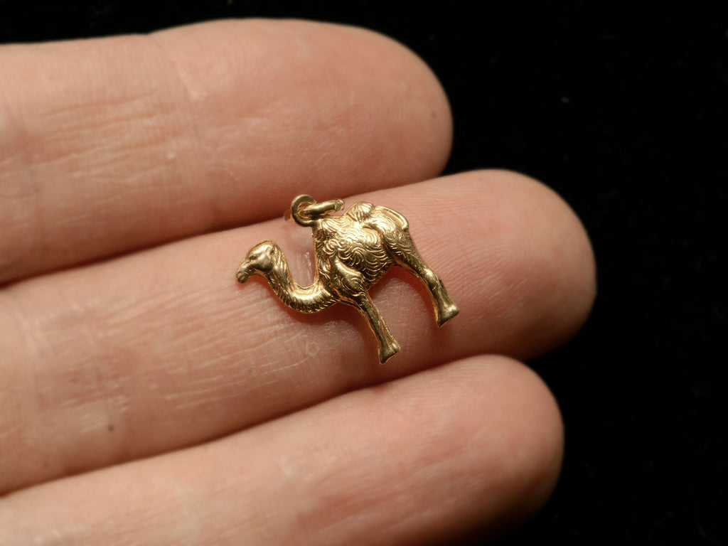 c1980 18K Camel Charm shown on hand for scale