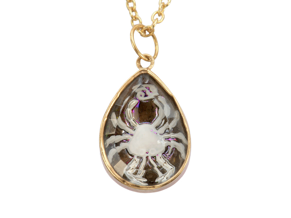 Detail of vintage Cancer zodiac charm with reverse carved crab in crystal and yellow gold. 