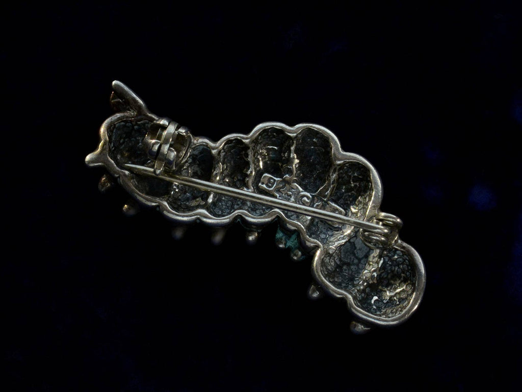 Reverse view of c1980 Silver Caterpillar Brooch (on black background)