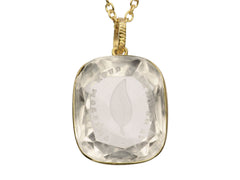 thumbnail of Detail of a c1820 Georgian era gold and crystal intaglio pendant carved with the image of an ivy leaf and the French phrase "Je Ne Change Qu'en Mourant." Shown on white background.