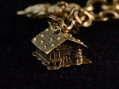 thumbnail of Detail view of yellow gold cottage charm on dark background.