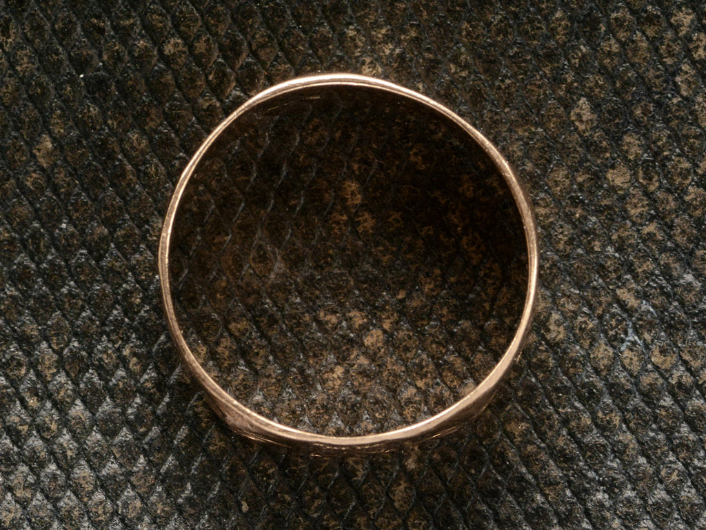 Side profile of a patterned 12K rose gold Victorian band, shown on dark textured background.