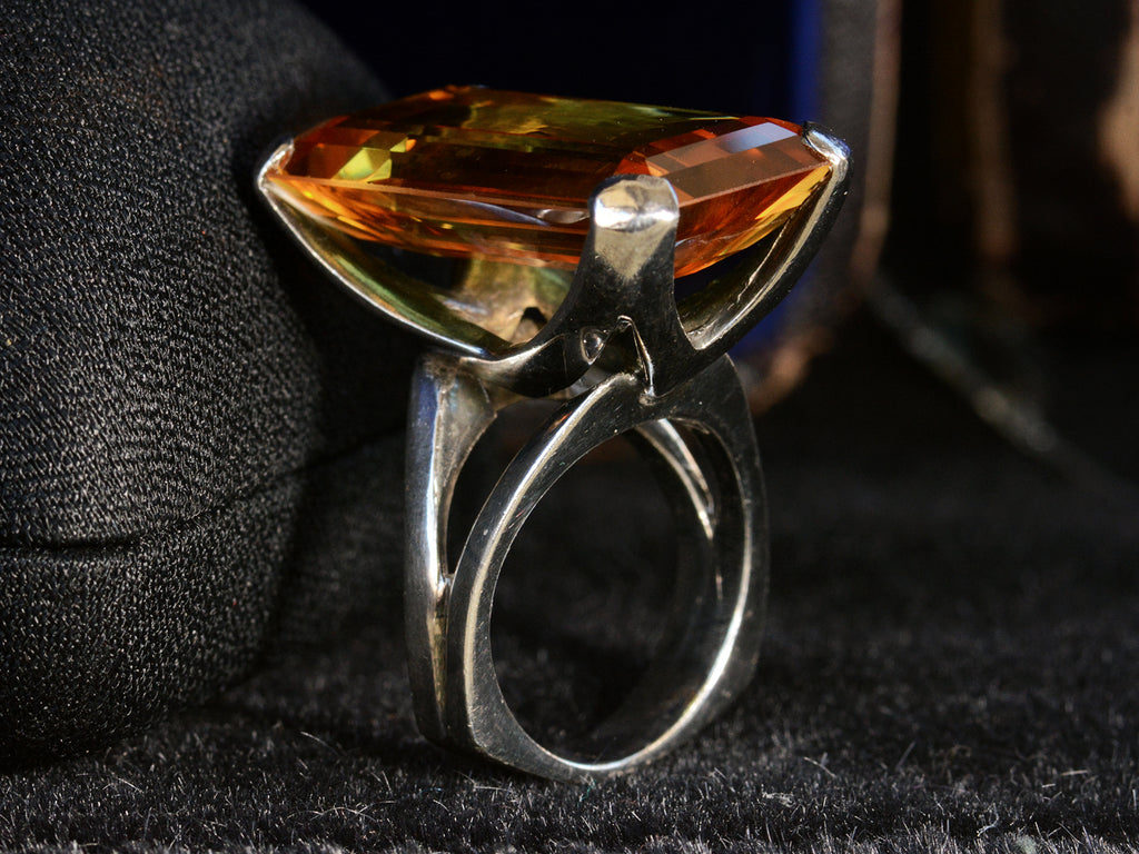 Angled side profile view of c1970 Orange Citrine and Silver Cocktail Ring (on dark background)