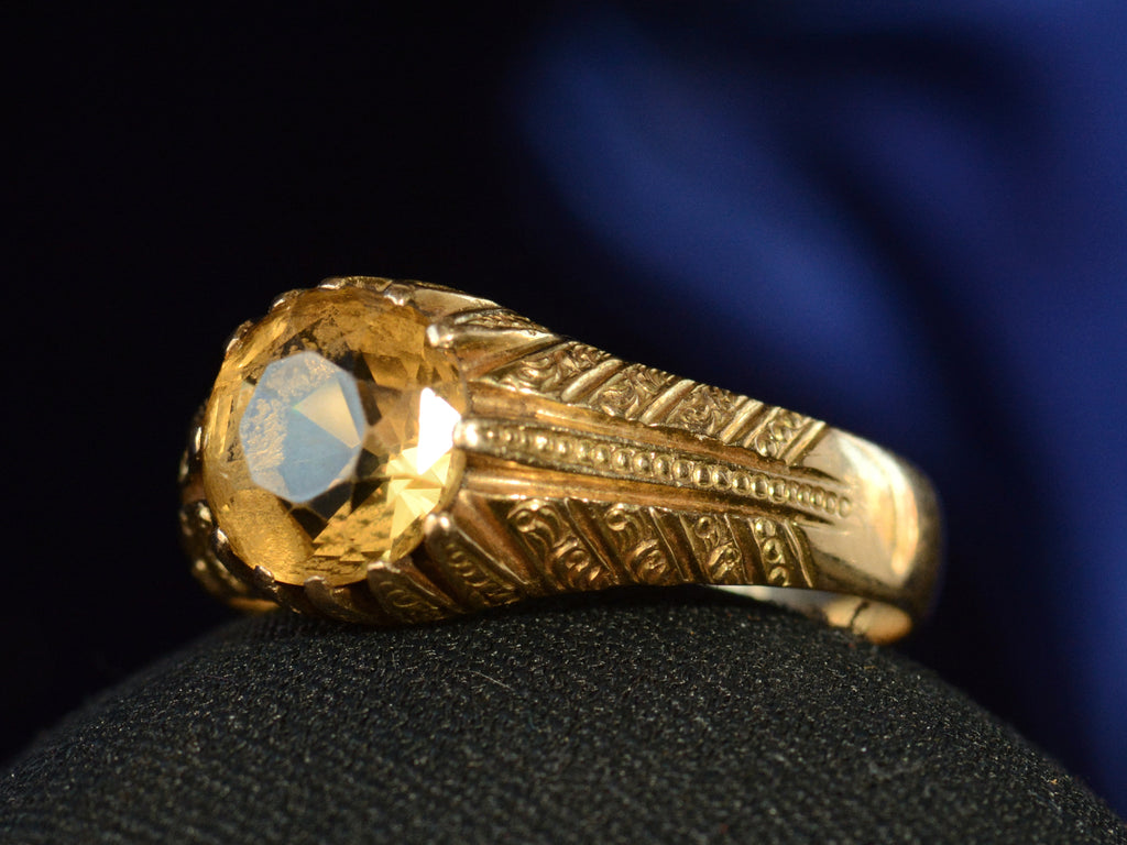 Right angle view of c1940 Portuguese Citrine Ring in Yellow Gold (shown on dark blue background)