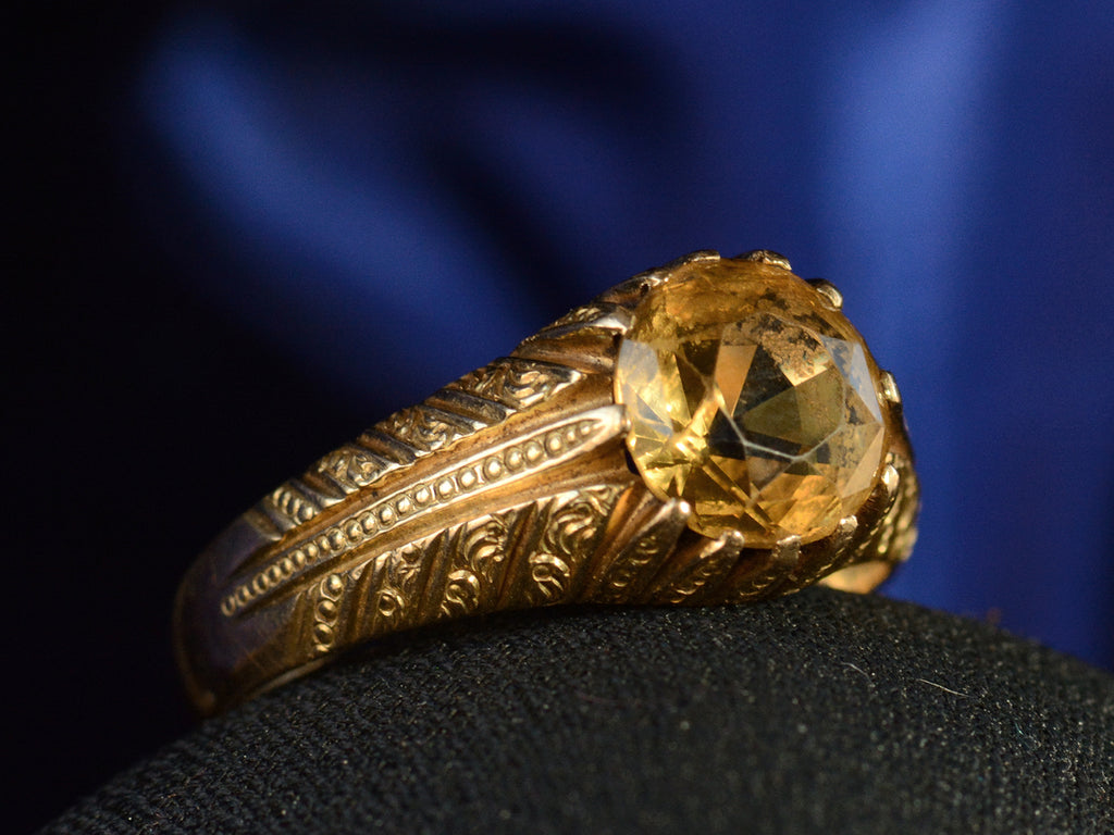 Left angle view of c1940 Portuguese Citrine Ring in Yellow Gold (shown on dark blue background)