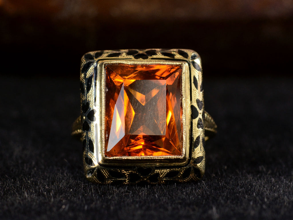 Front profile of c1930 Art Deco Orange Citrine Ring with Black Enamel Decoration on Yellow Gold (Shown on dark background)