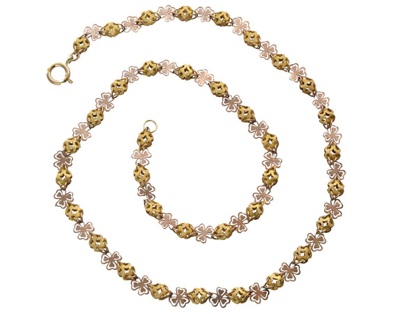 A Victorian c1880 Filigreed Rose and Yellow Gold Chain (shown spiraled on a white background)