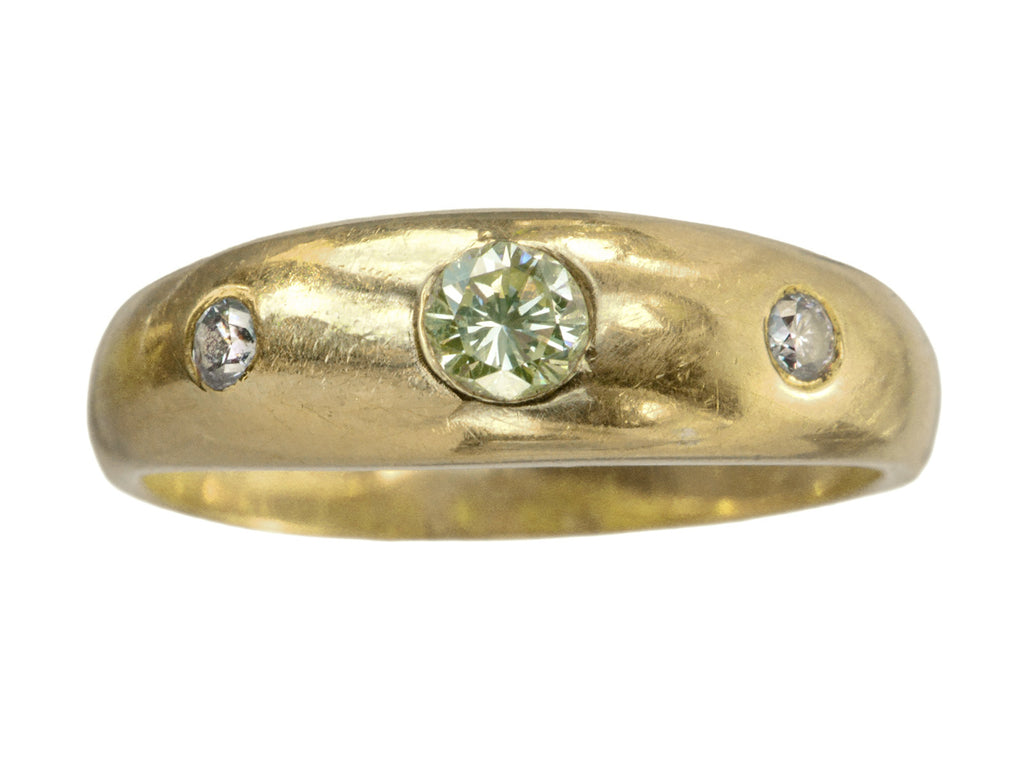A rounded vintage 18k yellow gold ring flush set with a light greenish-yellow round diamond in between two smaller light pink diamonds, shown on white background.