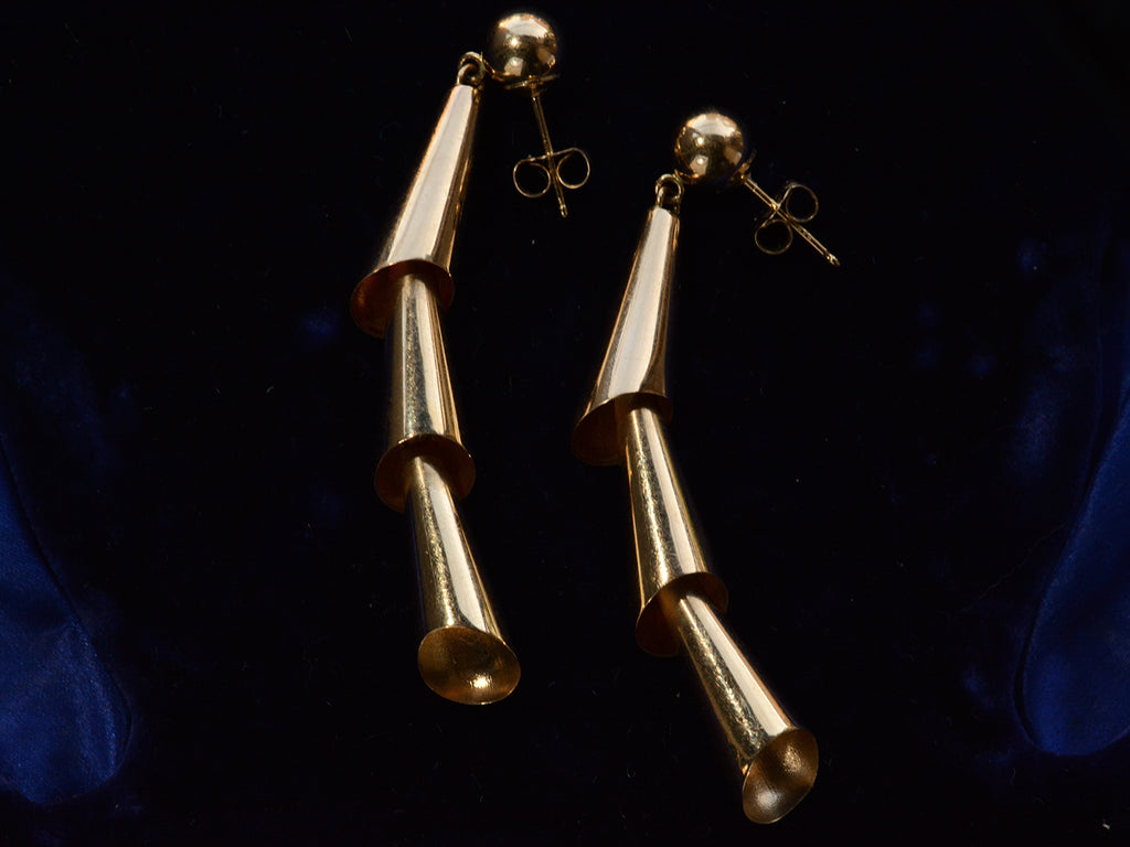 Side angle view of c1980 Articulated Gold Earrings (on dark blue background)