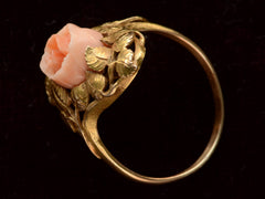 thumbnail of Side profile view of 1930 ring with a coral rose surrounded by gold leaves and vines, shown on black background.