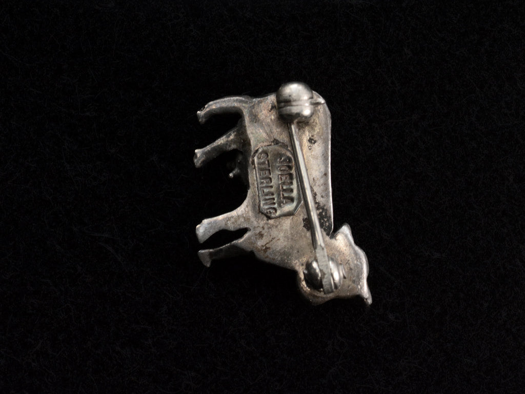 Reverse side of c1980 Tiny Silver Cow Brooch (on black background). Stamped "JOELLA STERLING"