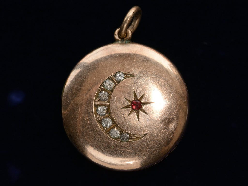 c1900 Rose Gold Filled Crescent Locket with Red and White Paste (front on black background)