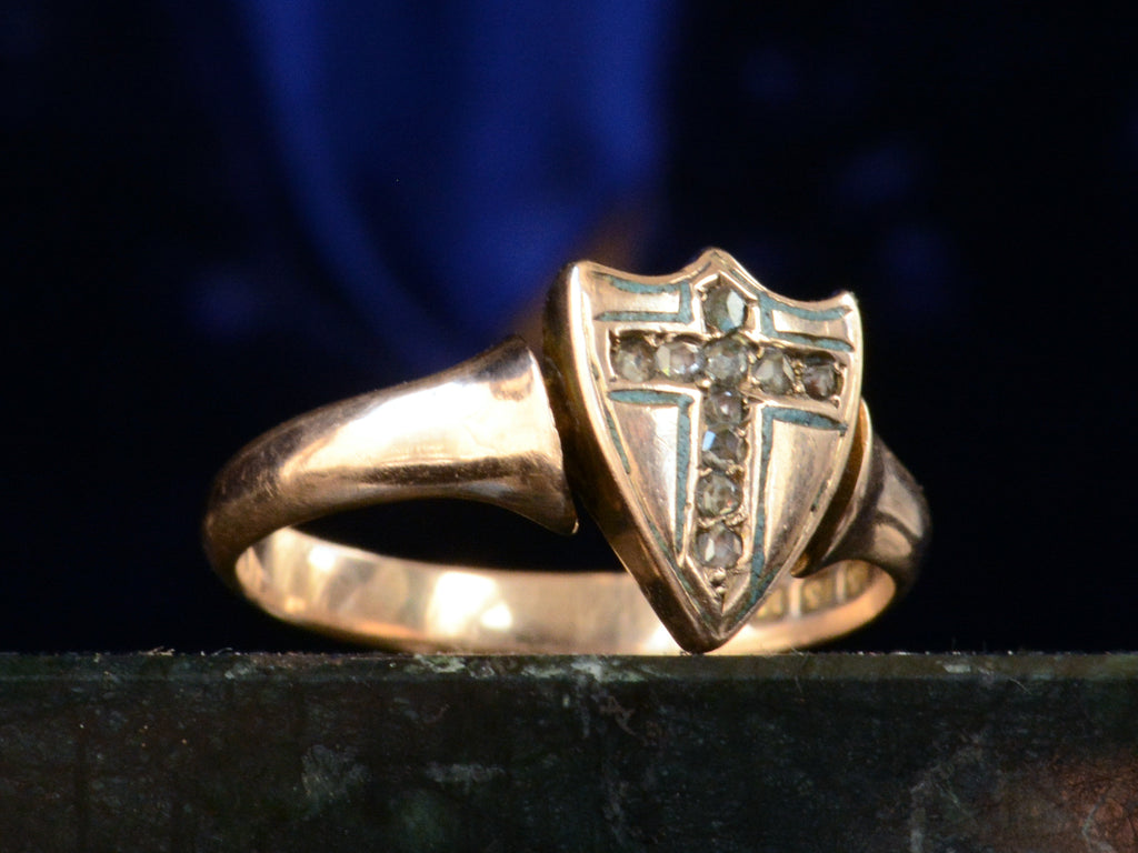 Left angle view of c1890 Diamond Cross Ring in Rose Gold (shown on dark blue background)