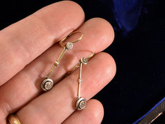 thumbnail of c1910 Diamond Drop Earrings in Platinum and 18K yellow gold, shown on hand for scale.