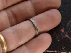 thumbnail of De Beers Talisman Blacked Gold Diamond Band (shown on hand for scale)